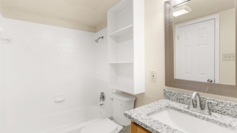 a bathroom with a white sink and toilet at The Delmar Place Apartment