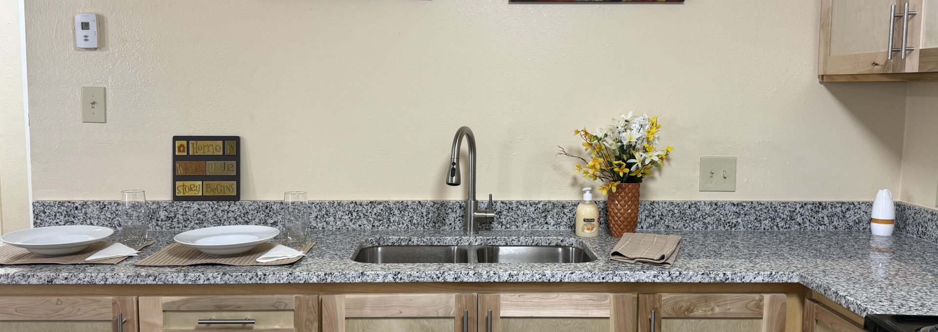 a kitchen with granite counter tops and stainless steel appliances at The Delmar Place Apartment