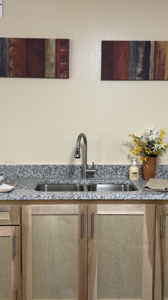 a kitchen with granite counter tops and stainless steel appliances at The Delmar Place Apartment